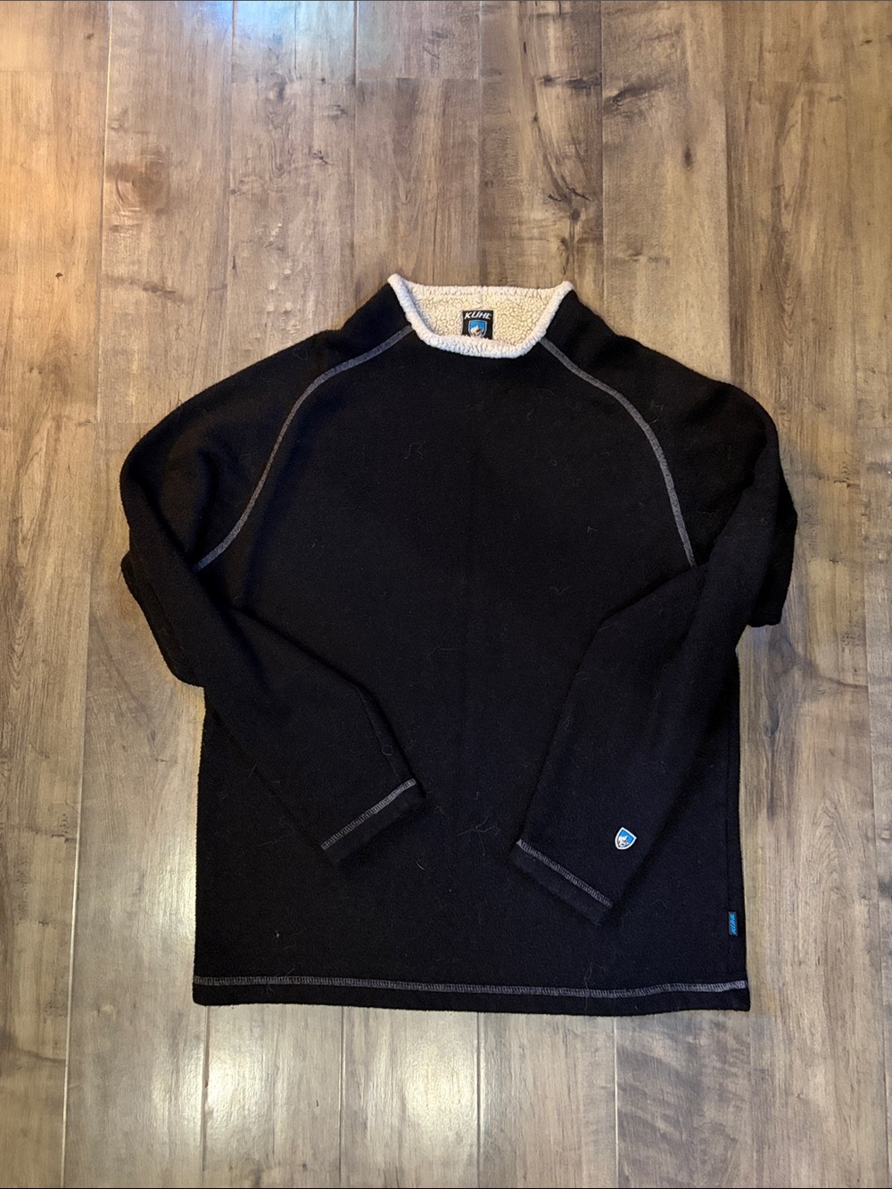 Men's Black Crewneck Kuhl fleece sweater.